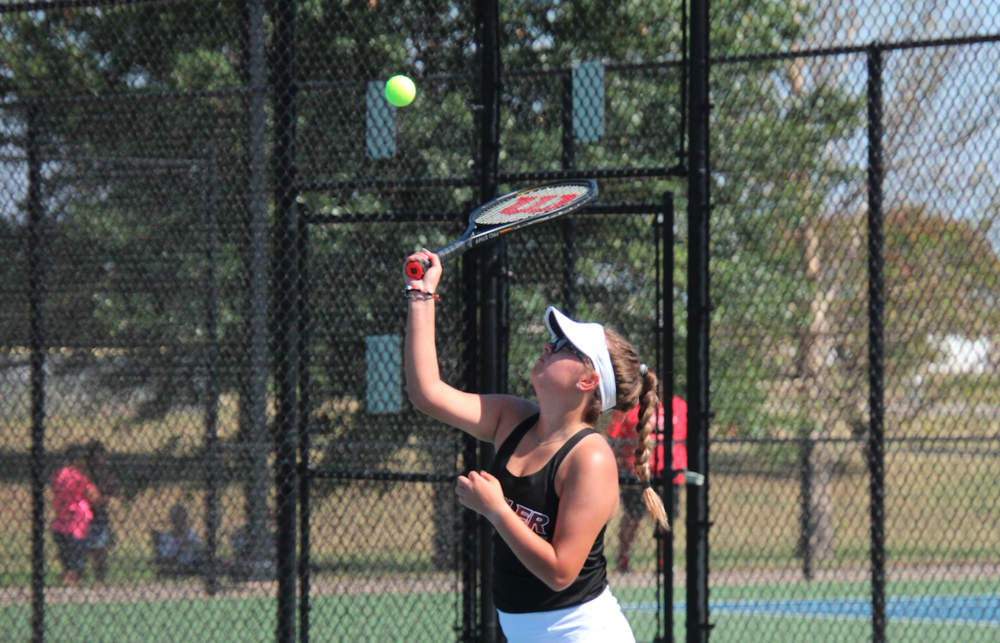 Haileigh Ruiz serves the ball at a Buhler Invitational tennis match last season. Photographer t. nickel