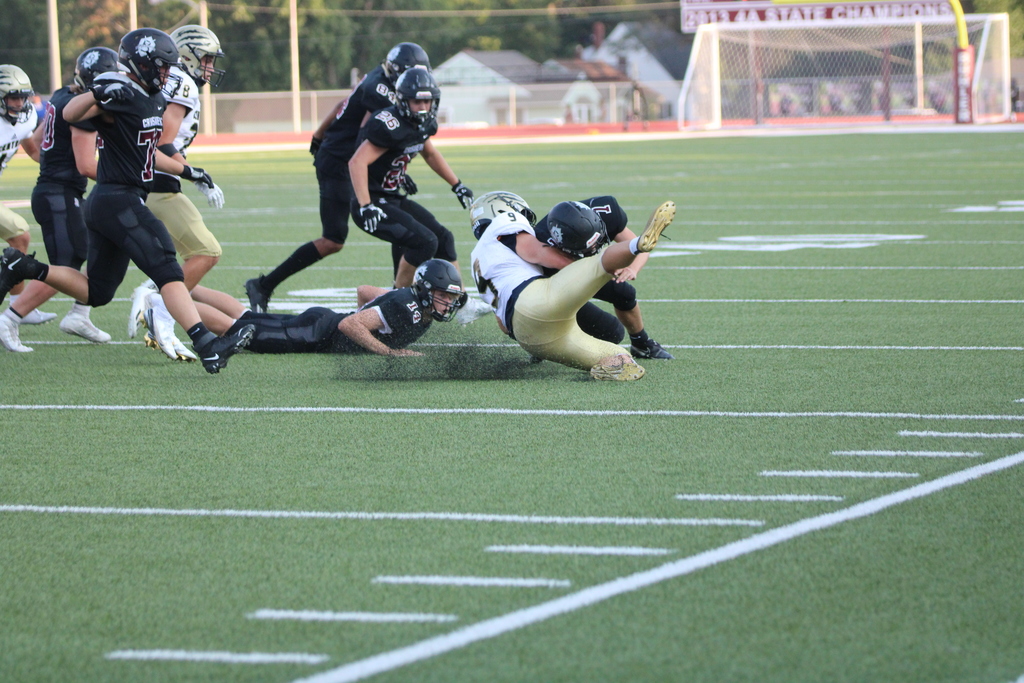 Bryce Ruda, jr.,  tackles an opposing player from Andover Central.