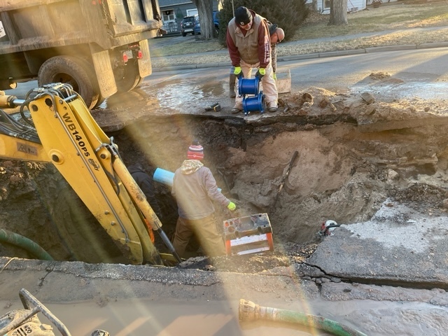 Picture of city workers working on water main break.